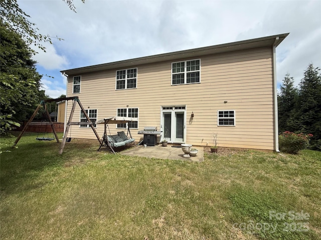 4504 Rockland Ct, High Point, NC 27265 - back of property with a playground, a patio area, and a lawn
