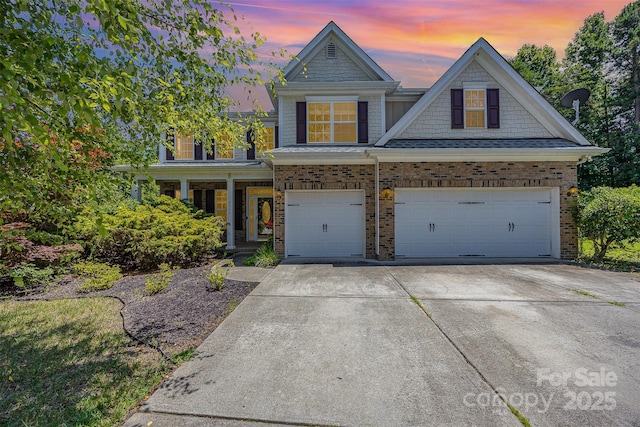 4504 Rockland Ct, High Point, NC 27265 - view of front of home featuring brick siding, driveway, covered porch, and an attached garage