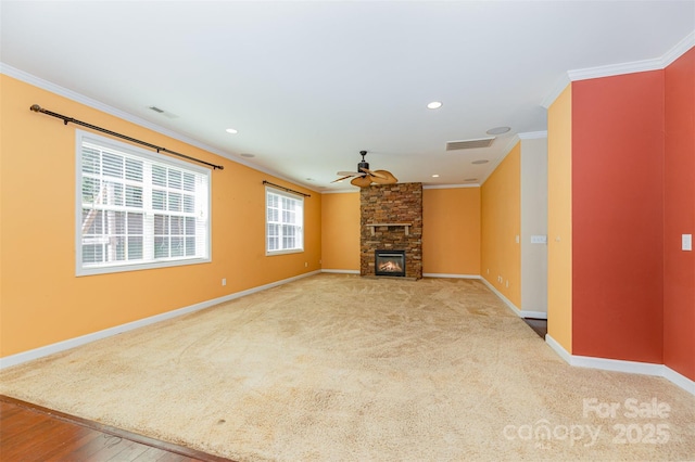 4504 Rockland Ct, High Point, NC 27265 - unfurnished living room featuring ornamental molding, a ceiling fan, a stone fireplace, recessed lighting, and carpet flooring