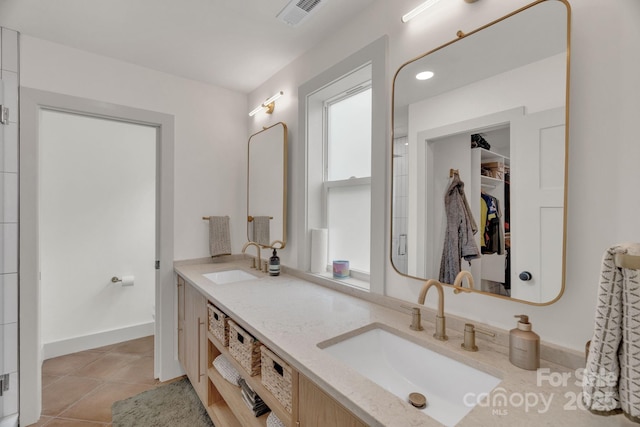 30 Spaulding Dr, Candler, NC 28715 - bathroom with a spacious closet, double vanity, tile patterned floors, and baseboards