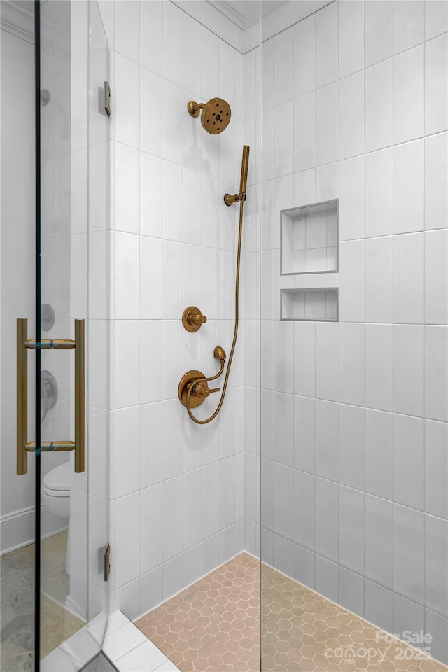 full bath featuring toilet and a tile shower