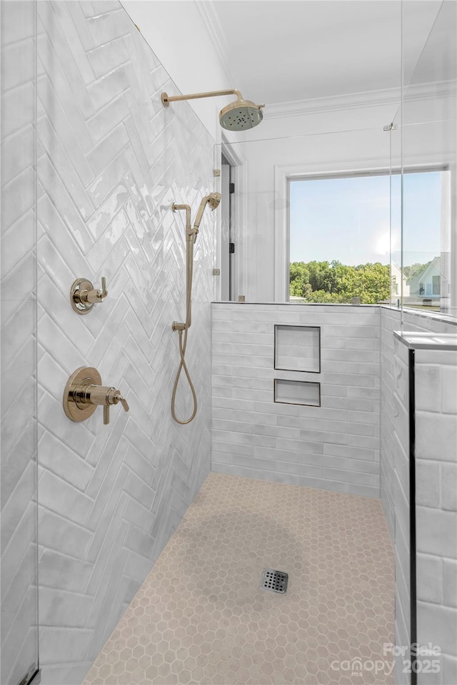 full bath featuring crown molding and tiled shower