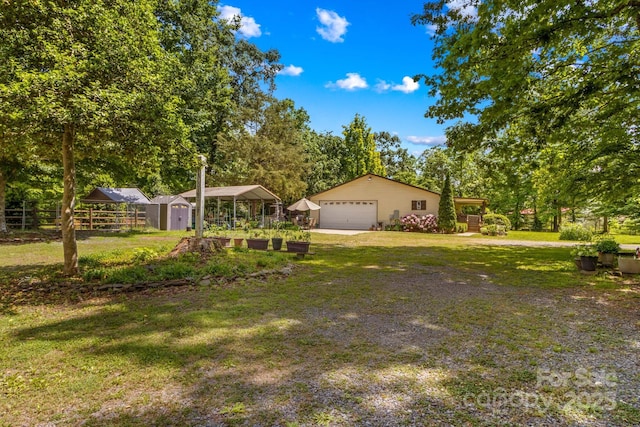 3755 River Rd, Richfield, NC 28137 - view of front of home featuring an outdoor structure, a detached garage, a storage shed, and view of scattered trees