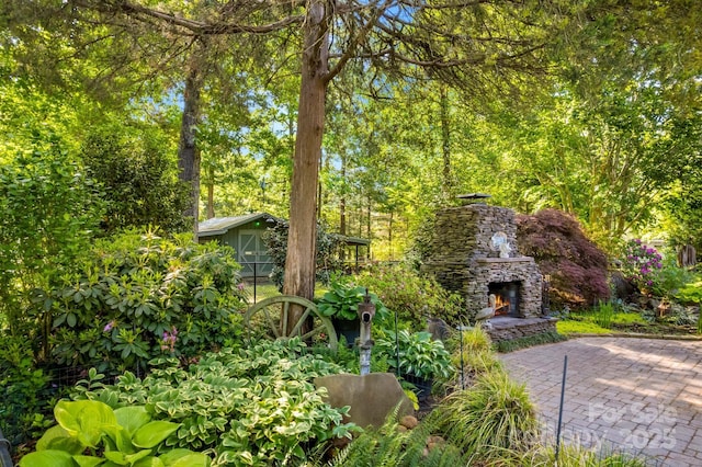 3755 River Rd, Richfield, NC 28137 - view of yard with an outdoor stone fireplace and a patio