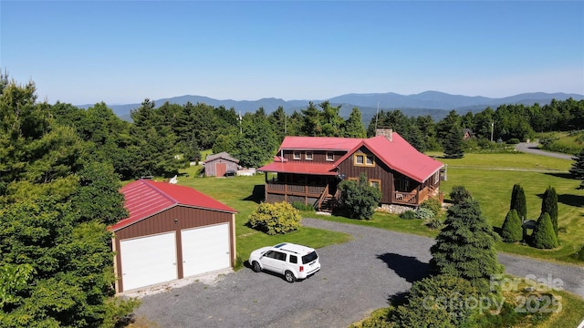 birds eye view of property with a forest view and a mountain view