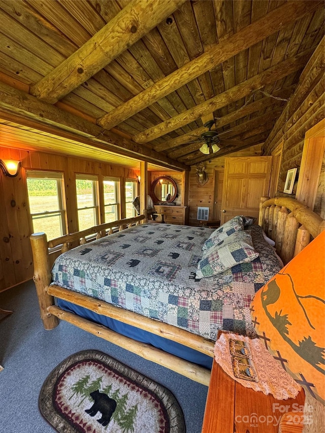 bedroom featuring wood walls, visible vents, carpet flooring, wood ceiling, and vaulted ceiling with beams