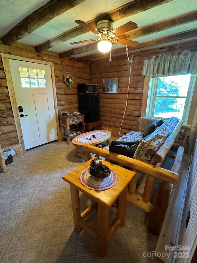 7348 Joe Johnson St, Newland, NC 28657 - carpeted living area with beam ceiling, rustic walls, and a ceiling fan