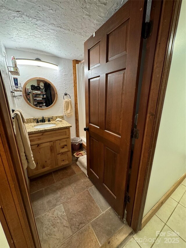 7348 Joe Johnson St, Newland, NC 28657 - bathroom with toilet, vanity, and a textured ceiling