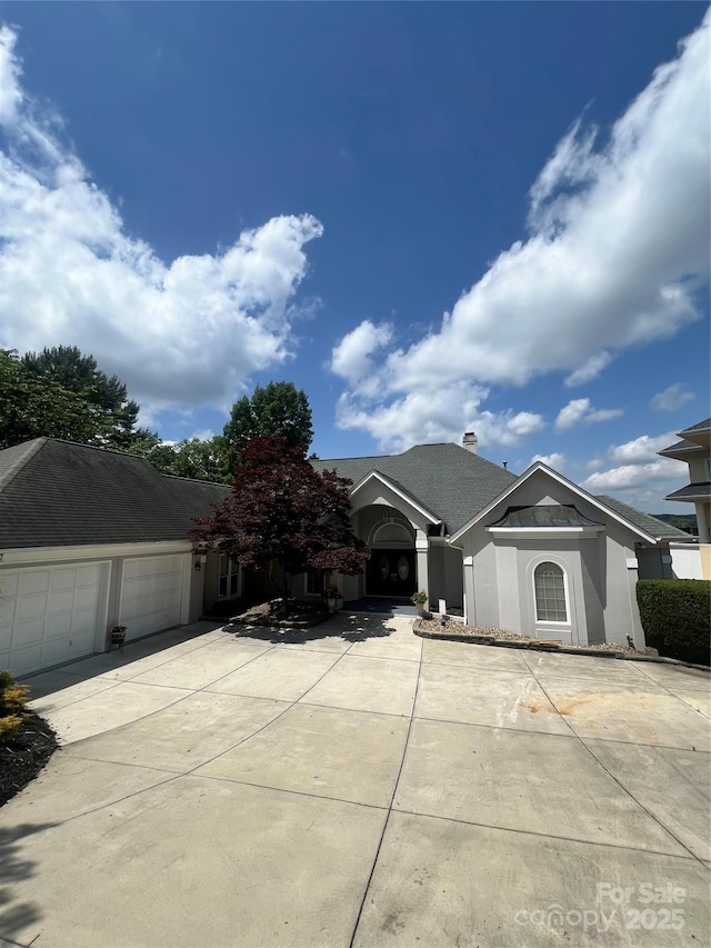 16108 Woolwine Rd, Charlotte, NC 28278 - ranch-style house with concrete driveway, an attached garage, and stucco siding