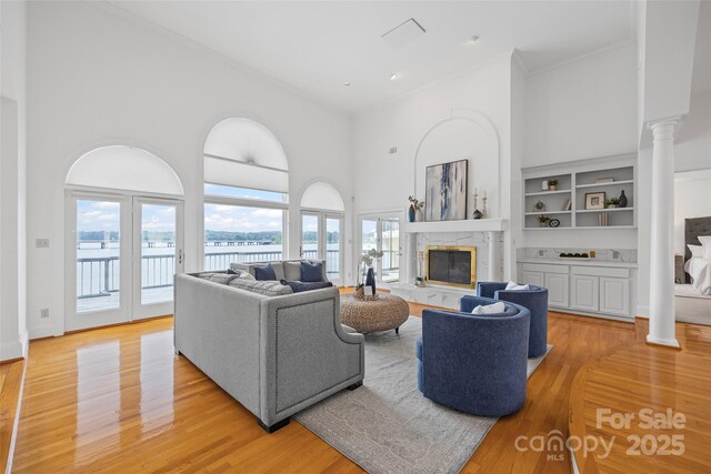 16108 Woolwine Rd, Charlotte, NC 28278 - living area with a towering ceiling, ornate columns, ornamental molding, plenty of natural light, and a high end fireplace