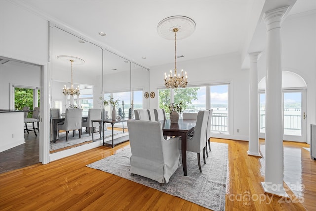 16108 Woolwine Rd, Charlotte, NC 28278 - dining space with a chandelier, decorative columns, wood finished floors, and a towering ceiling