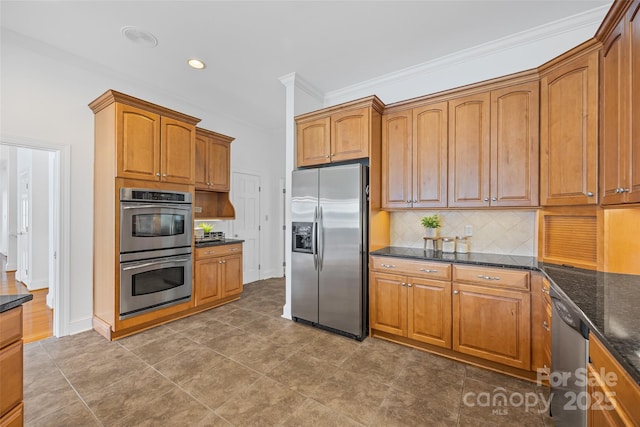 16108 Woolwine Rd, Charlotte, NC 28278 - kitchen featuring stainless steel appliances, backsplash, brown cabinetry, crown molding, and dark stone countertops