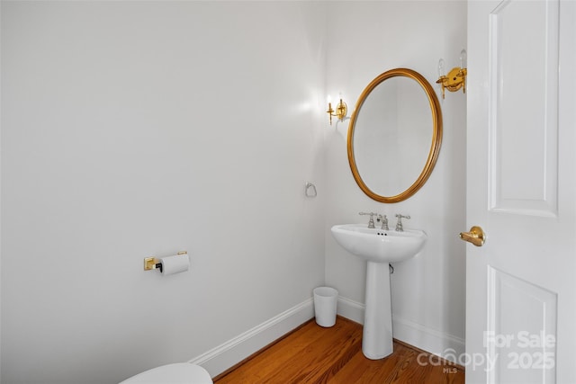 16108 Woolwine Rd, Charlotte, NC 28278 - half bathroom featuring wood finished floors, baseboards, and toilet