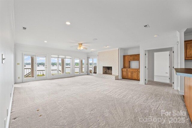 16108 Woolwine Rd, Charlotte, NC 28278 - unfurnished living room with healthy amount of natural light, a water view, ceiling fan, crown molding, and light colored carpet