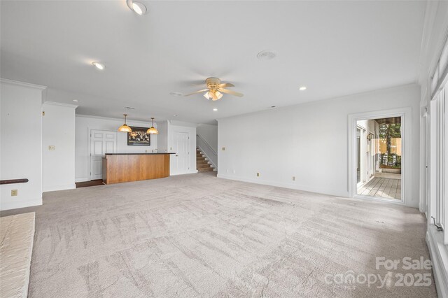 16108 Woolwine Rd, Charlotte, NC 28278 - unfurnished living room with ceiling fan, stairway, crown molding, light colored carpet, and baseboards