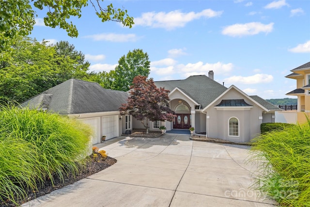 16108 Woolwine Rd, Charlotte, NC 28278 - view of front facade with a garage, french doors, stucco siding, roof with shingles, and concrete driveway