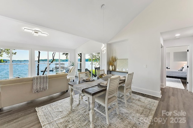 9115 Clement Cir, Terrell, NC 28682 - dining space with wood finished floors, lofted ceiling, baseboards, and a water view