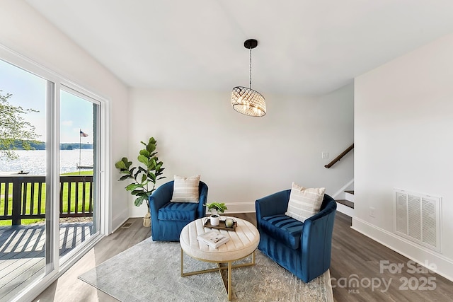 9115 Clement Cir, Terrell, NC 28682 - sitting room with a water view, stairs, wood finished floors, baseboards, and a chandelier