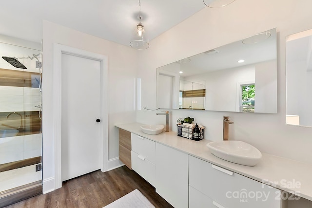 9115 Clement Cir, Terrell, NC 28682 - bathroom featuring double vanity, wood finished floors, and a stall shower