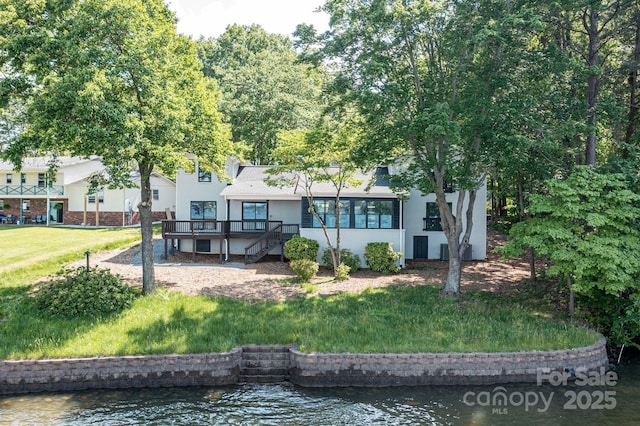 9115 Clement Cir, Terrell, NC 28682 - rear view of house featuring a lawn, stucco siding, and a deck with water view