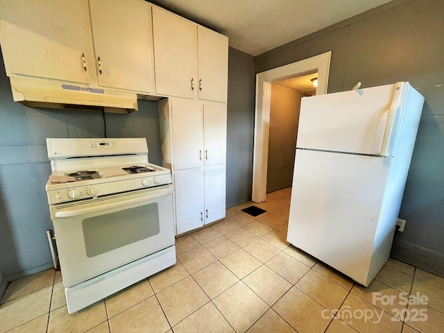 kitchen with under cabinet range hood, light tile patterned flooring, white appliances, and white cabinets