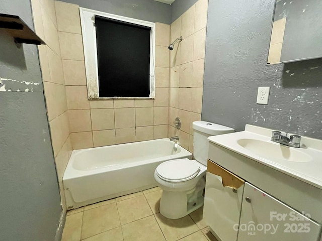 bathroom with toilet, shower / bath combination, tile patterned flooring, a textured wall, and vanity