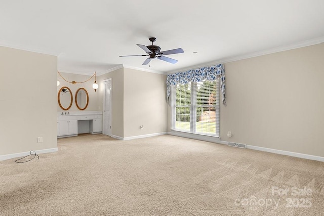 12117 Idlewild Rd, Matthews, NC 28105 - unfurnished living room featuring crown molding, baseboards, light carpet, and ceiling fan