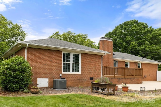 12117 Idlewild Rd, Matthews, NC 28105 - rear view of property featuring brick siding, cooling unit, a chimney, a patio, and a lawn
