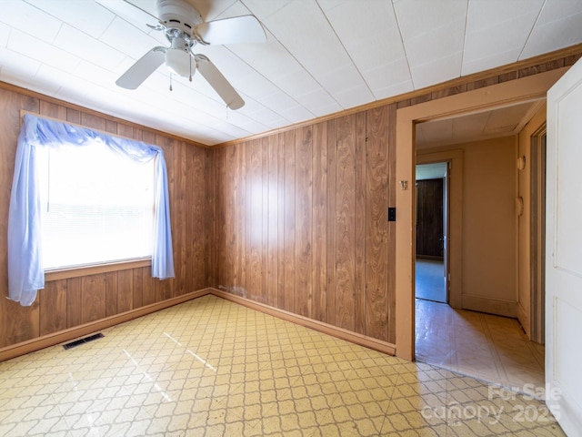 1470 Hilltop St, Albemarle, NC 28001 - spare room with wood walls, baseboards, a ceiling fan, and visible vents