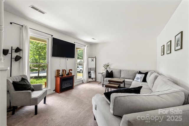 living room with light colored carpet and visible vents