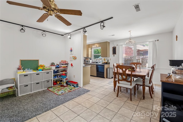 dining area featuring light tile patterned flooring, a ceiling fan, track lighting, and visible vents