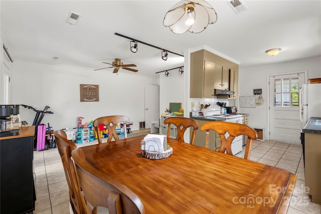 dining space featuring rail lighting, light tile patterned floors, visible vents, and a ceiling fan