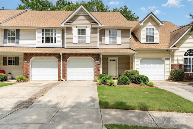 10421 Columbia Crest Ct, Charlotte, NC 28270 - townhome / multi-family property featuring a shingled roof, driveway, and brick siding