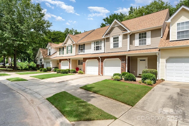 10421 Columbia Crest Ct, Charlotte, NC 28270 - view of property featuring driveway, a shingled roof, a front yard, an attached garage, and brick siding