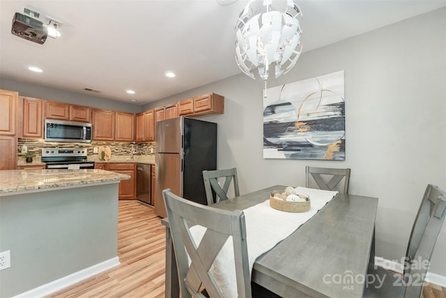 10421 Columbia Crest Ct, Charlotte, NC 28270 - dining space featuring light wood finished floors, a chandelier, and recessed lighting