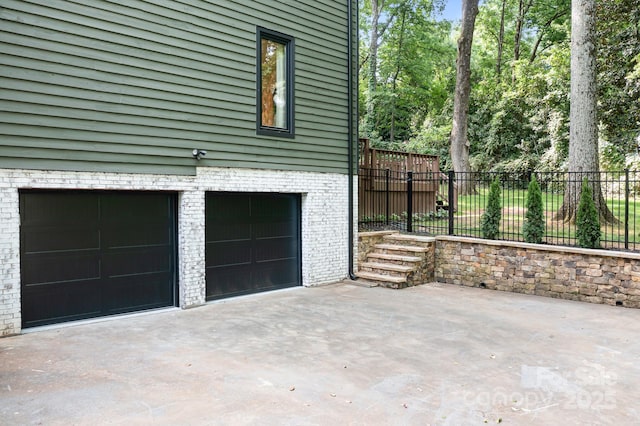 4316 Old Saybrook Ct, Charlotte, NC 28211 - view of home's exterior with driveway, fence, an attached garage, and brick siding