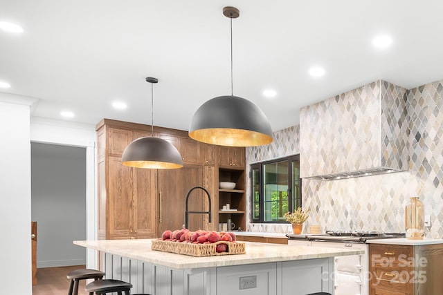 4316 Old Saybrook Ct, Charlotte, NC 28211 - kitchen with wall chimney range hood, recessed lighting, light stone counters, a kitchen island, and a kitchen breakfast bar