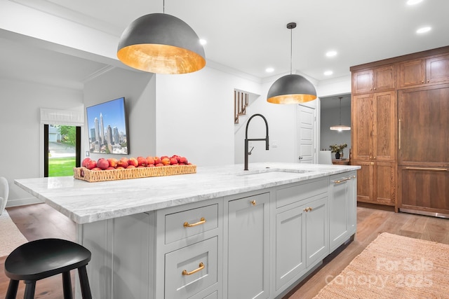 4316 Old Saybrook Ct, Charlotte, NC 28211 - kitchen with a sink, recessed lighting, crown molding, light stone countertops, and light wood finished floors