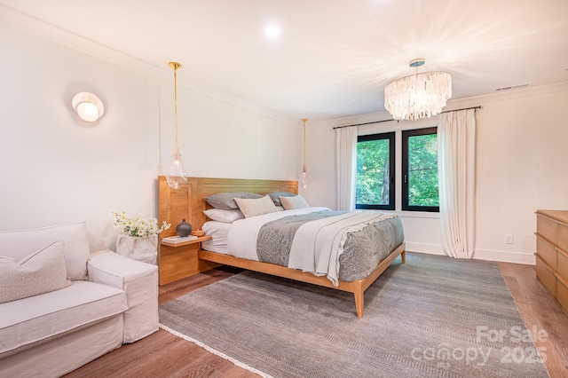 4316 Old Saybrook Ct, Charlotte, NC 28211 - bedroom with wood finished floors, a chandelier, and crown molding