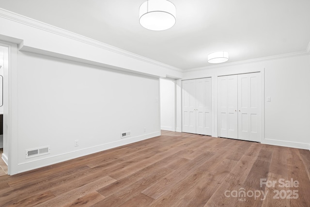 4316 Old Saybrook Ct, Charlotte, NC 28211 - unfurnished bedroom with two closets, wood finished floors, crown molding, and baseboards
