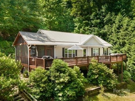 55 Christine Ct, Waynesville, NC 28786 - view of front of property with a deck, a wooded view, and a metal roof