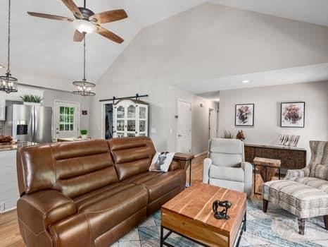 55 Christine Ct, Waynesville, NC 28786 - living area featuring a ceiling fan, high vaulted ceiling, light wood-style floors, and a chandelier