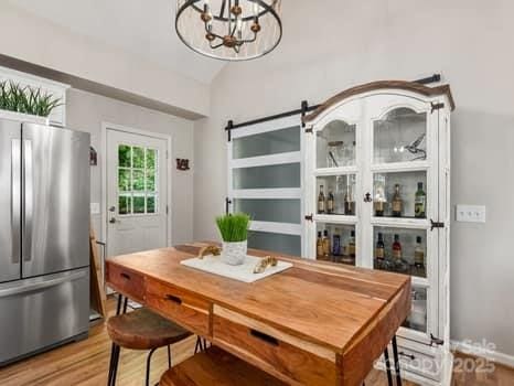 55 Christine Ct, Waynesville, NC 28786 - dining room with wood finished floors, lofted ceiling, and a chandelier
