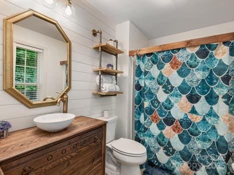 55 Christine Ct, Waynesville, NC 28786 - full bath with vanity, curtained shower, and wooden walls