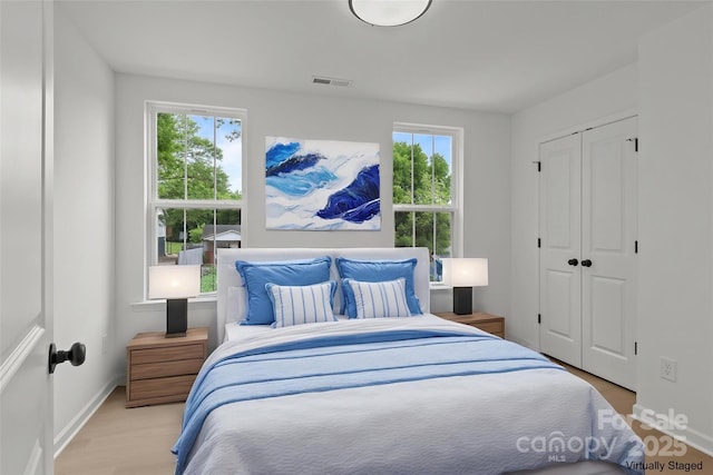 518 Herms Ave, Mount Holly, NC 28120 - bedroom featuring multiple windows, baseboards, and a closet