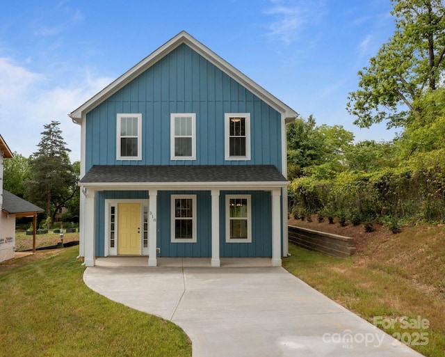 518 Herms Ave, Mount Holly, NC 28120 - view of front of home featuring board and batten siding, a front lawn, covered porch, and roof with shingles