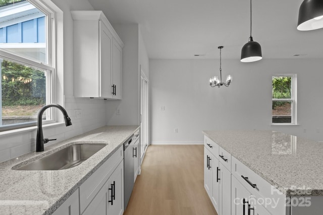 518 Herms Ave, Mount Holly, NC 28120 - kitchen with a sink, light wood finished floors, tasteful backsplash, dishwasher, and decorative light fixtures