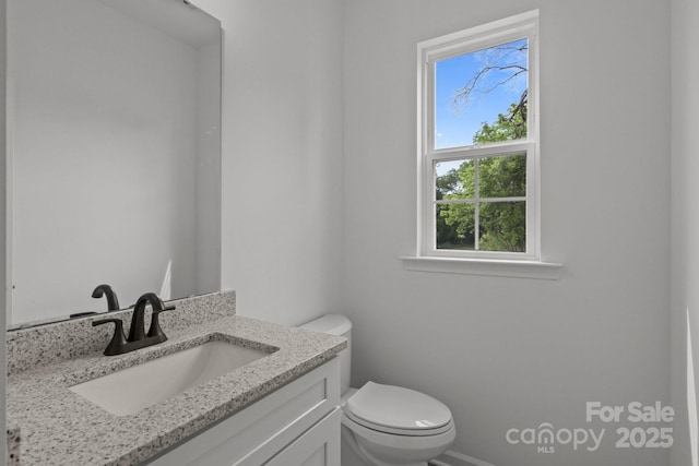 518 Herms Ave, Mount Holly, NC 28120 - bathroom featuring toilet, vanity, and baseboards