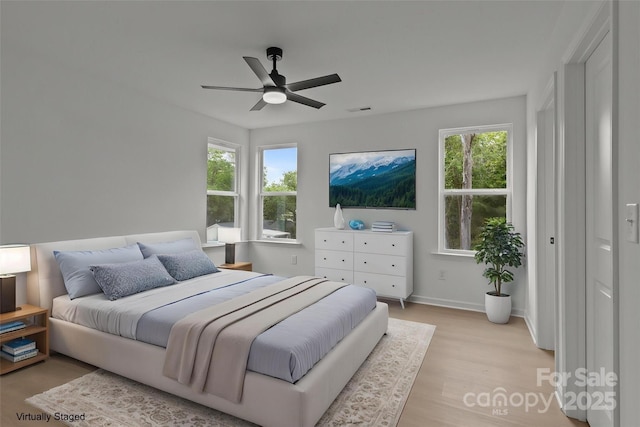 518 Herms Ave, Mount Holly, NC 28120 - bedroom with multiple windows, light wood finished floors, baseboards, and a ceiling fan