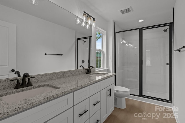 518 Herms Ave, Mount Holly, NC 28120 - full bathroom with toilet, a stall shower, wood finished floors, and double vanity